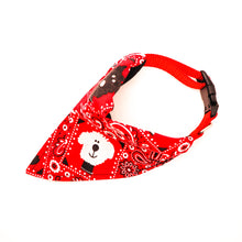 Load image into Gallery viewer, Top overhead view of Classic red bandana print over-the-collar bandana on a dog collar. Has classic bandana pattern with black and white dogs and white bones. Displayed on a white background.