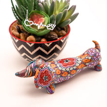 Load image into Gallery viewer, Silver necklace with open heart, heartbeat rhythm, and open pet paw. Displayed on succulent plant with a cute mosaic dachsund figurine.