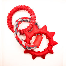 Load image into Gallery viewer, Overhead view picture of Dogzilla Dino Links dog toy. Toy has two hard red rubber rings connected by a twisted red/light gray/dark gray rope ring. One hard rubber ring has ridges for texture. The second rubber ring has pointed spikes. Displayed on a white background.