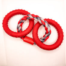 Load image into Gallery viewer, Overhead view picture of Dogzilla Lockin' Links dog toy. Toy has two hard red rubber rings connected by a twisted red/light gray/dark gray rope ring. Both hard rubber rings have raised nubs for texture. Displayed on a white background.