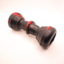Load image into Gallery viewer, Angled view picture of Dogzilla Strong Chewer Bone dog toy. Bone is hard black rubber with red accents. Displayed on a white background.