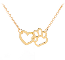 Load image into Gallery viewer, Gold tone necklace with open heart charms intertwined with open pet paw charms. Displayed on white background.